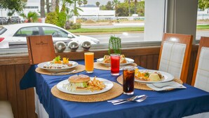 A table set with food and drinks, a view of the street outside, and a sign reading "Sat5ores".