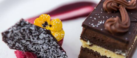 A dessert with chocolate and a red item with yellow flowers.