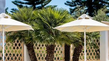 Seasonal outdoor pool, open 9:00 AM to 8:00 PM, pool umbrellas