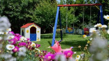 Children can play on the swing set and in the adjacent playhouse.