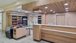 A modern retail store with wooden paneling and a clean, organized layout. - Hilton Garden Inn Tampa Airport Westshore (Tampa)
