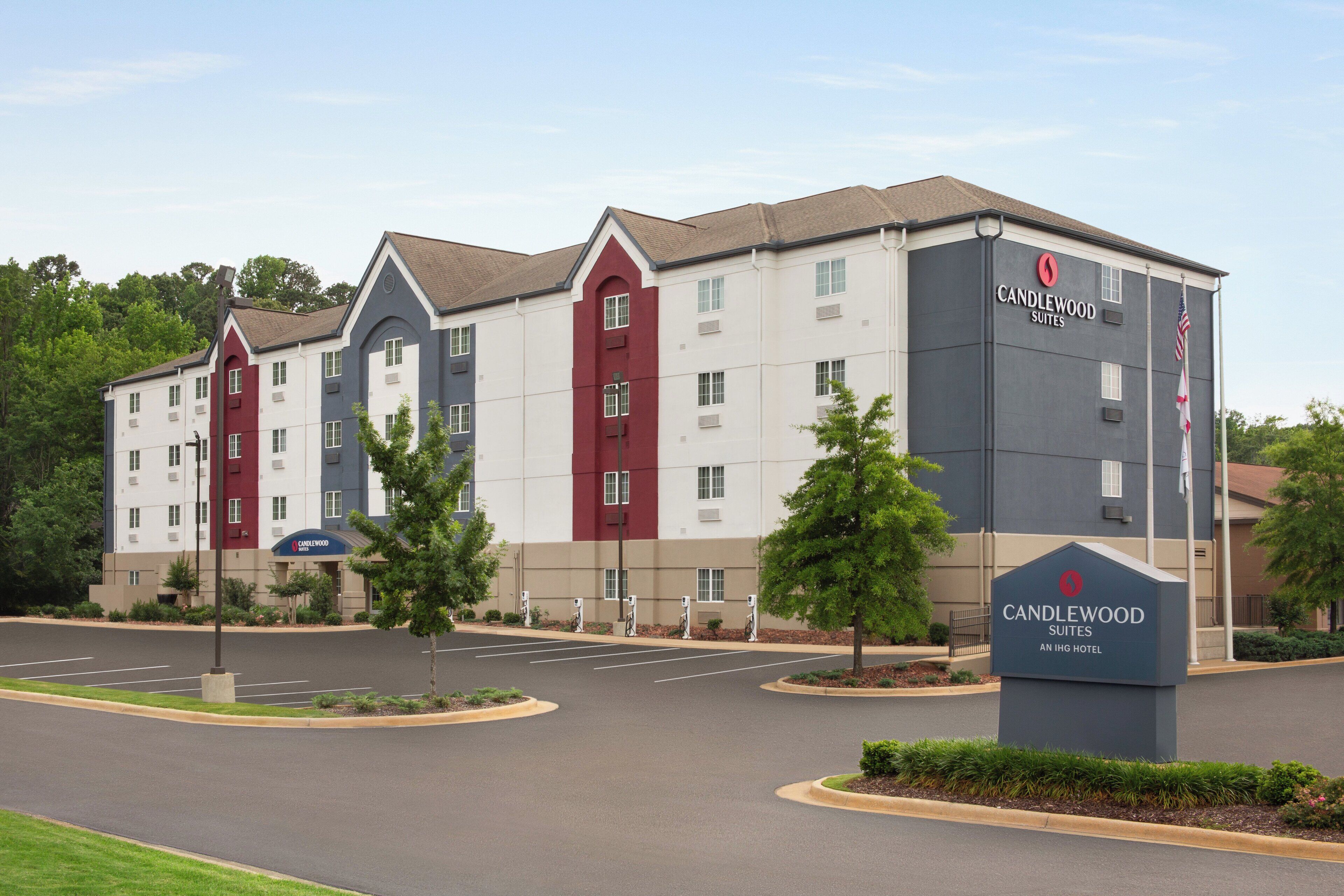 A multi-story hotel with a modern design, featuring a mix of red and white exterior colors.