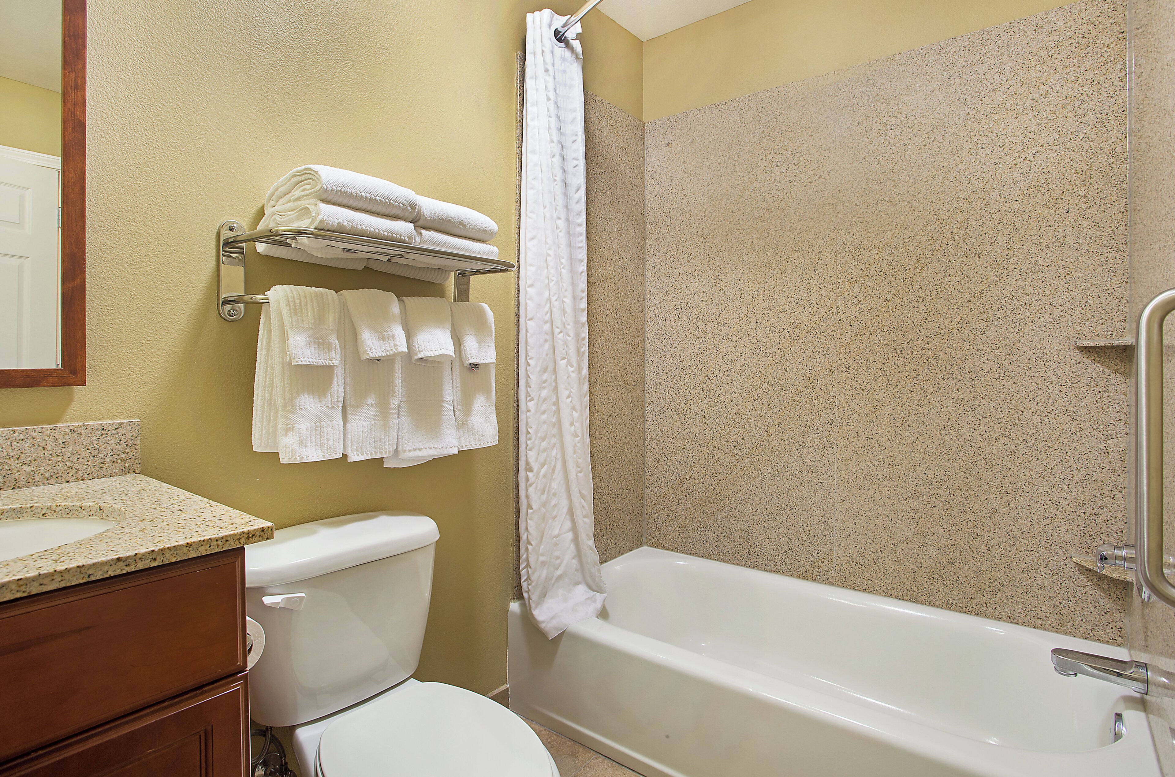 A bathroom with a toilet, sink, and bathtub.