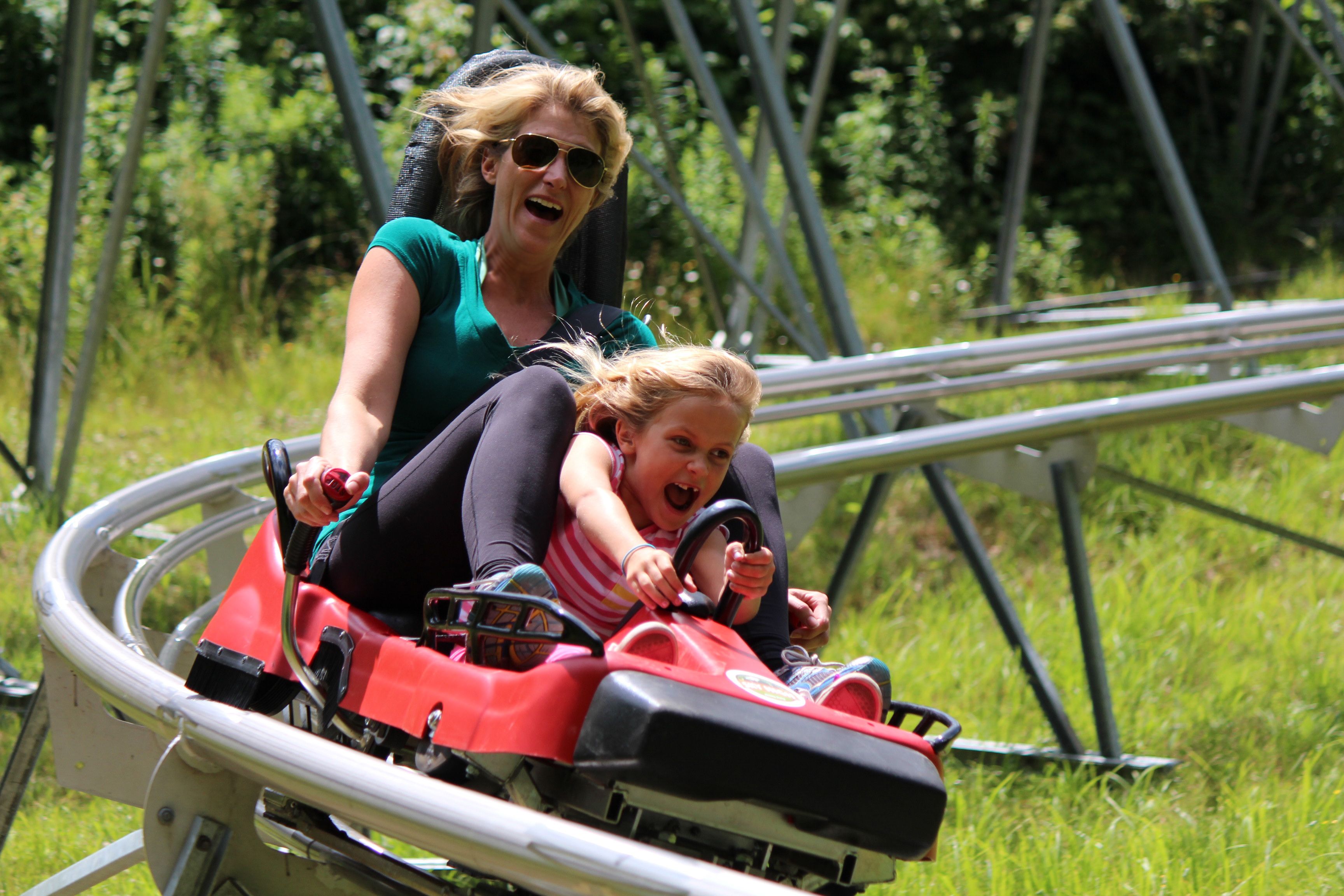 A woman and a child on a red amusement ride.