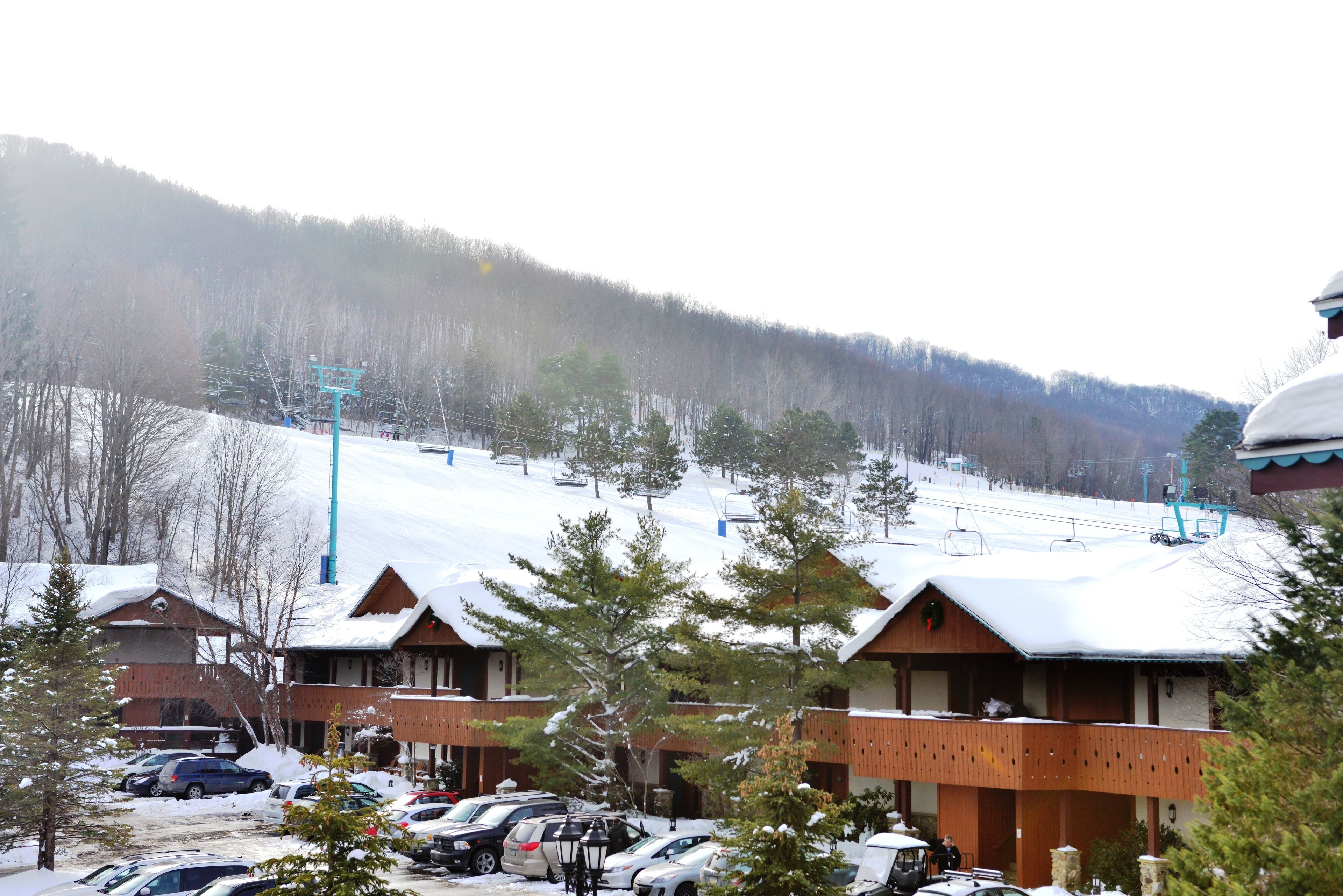 A ski resort with cabins and a parking lot.