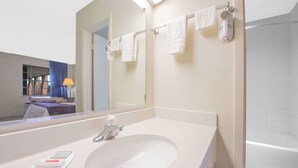 A bathroom with a sink, mirror, towel rack, and a shower. - Holiday Inn Express & Suites Borger by IHG (Borger)