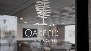 A modern interior with a logo for Oakfield Hotel & Suites. - Oakfield Hotel & Suites, Ascend Collection, Rochester-Pittsford NY (Rochester)