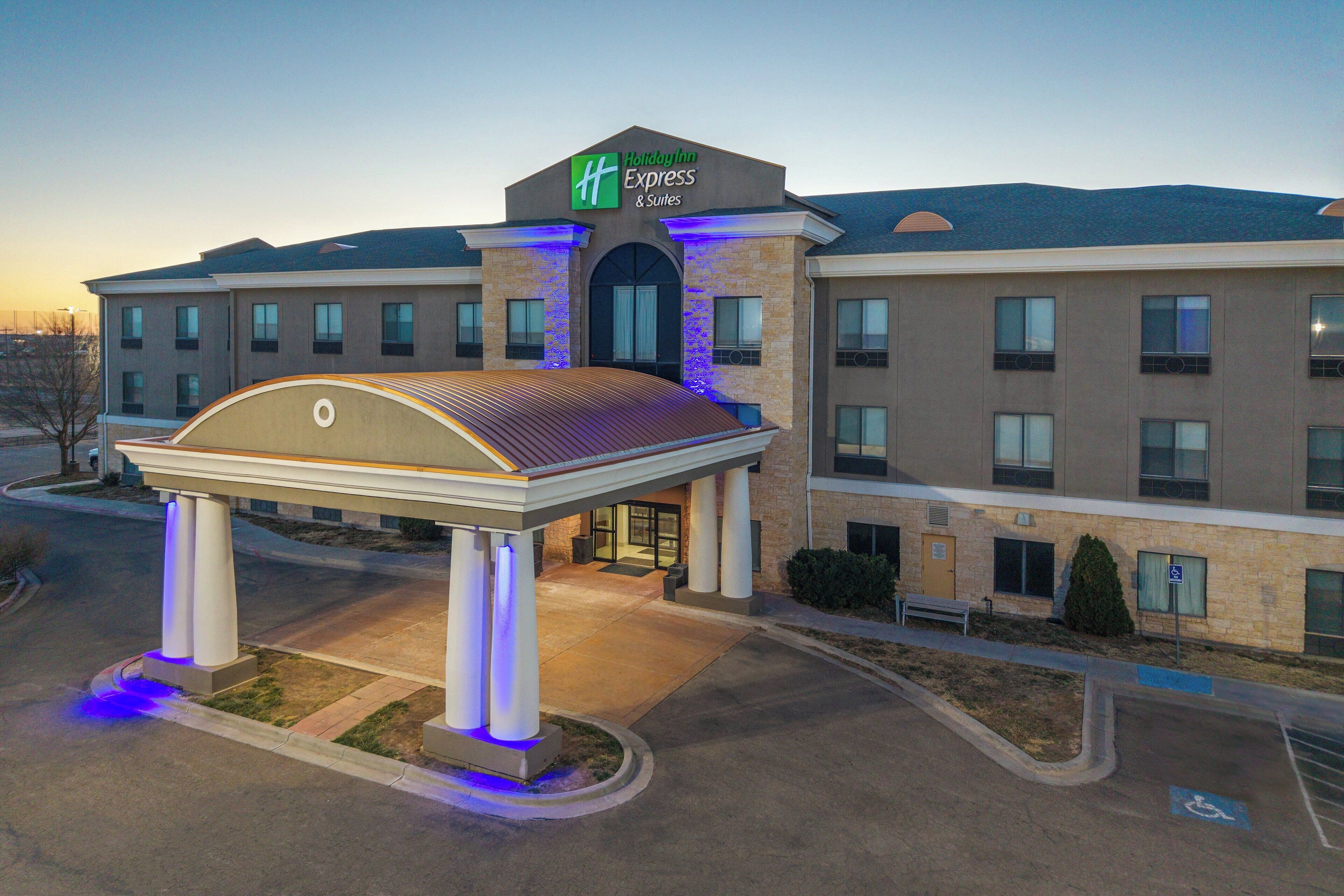 A Holiday Inn Express hotel with a covered entrance, multiple floors, and a parking lot.
