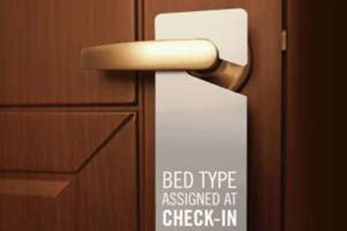A door with a sign that reads "BED TYPE ASSIGNED AT CHECK-IN".