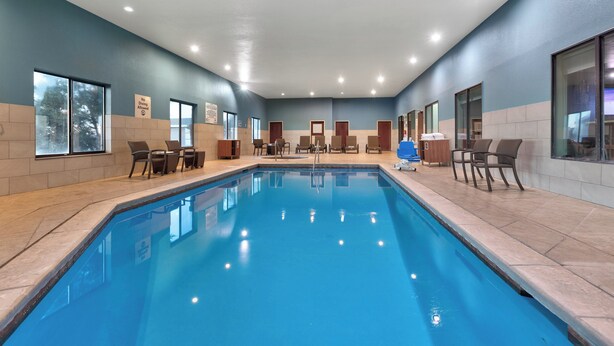 An indoor swimming pool with clear blue water, surrounded by beige tiled walls and a blue ceiling. - Holiday Inn Express Amarillo South by IHG (Amarillo)