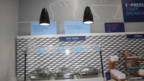 A breakfast buffet area with labeled sections for hot food and cereal, and a sign promoting Express Start Breakfast. - Holiday Inn Express Hotel & Suites Shamrock North by IHG (Shamrock)