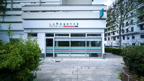 A modern hotel facade with a sign reading "LaRegence hotel".