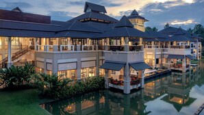 A resort with multiple buildings connected by walkways over water, featuring outdoor seating areas and a pool. - Le Meridien Chiang Rai Resort, Thailand (Chiang Rai)