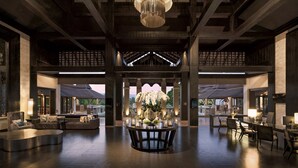 A spacious lobby with a central round table surrounded by seating, large windows, and a chandelier. - Le Meridien Chiang Rai Resort, Thailand (Chiang Rai)