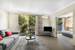 Deluxe One Bedroom Spa Apartment | Living area | Flat-screen TV