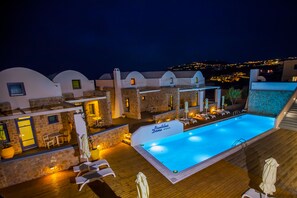 Relax by the pool surrounded by arched structures and lounge chairs.