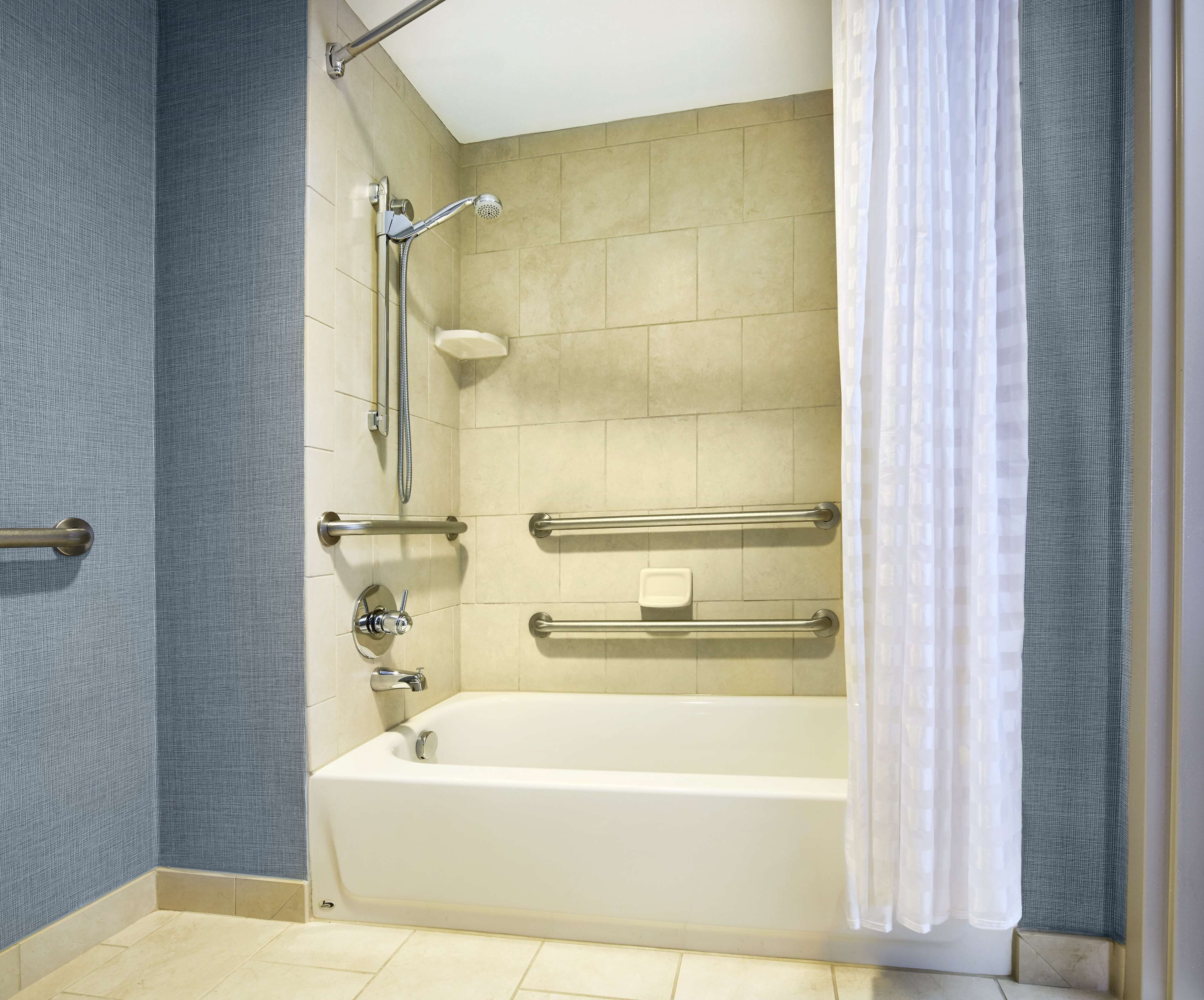 combined shower/bathtub, designer toiletries, hair dryer, towels