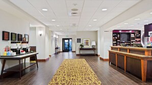 A hotel lobby with a reception desk, a coffee station, and a carpeted walkway. - Hampton Inn & Suites by Hilton Walla Walla (Walla Walla)