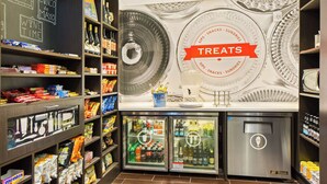 A store with shelves stocked with snacks, drinks, and a 'Treats' sign. - Hampton Inn & Suites by Hilton Walla Walla (Walla Walla)