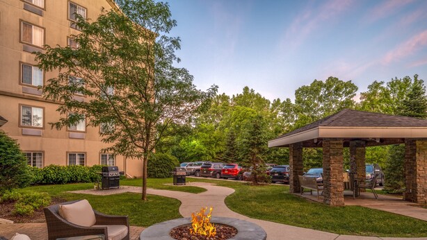 A courtyard with a fire pit, outdoor seating, and a covered pavilion. - Staybridge Suites Milwaukee Airport South by IHG (Franklin)