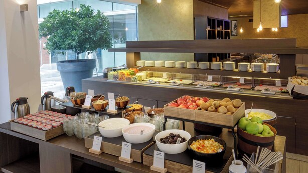 A buffet with various food items and a coffee station. - DoubleTree by Hilton Milan (Milan)