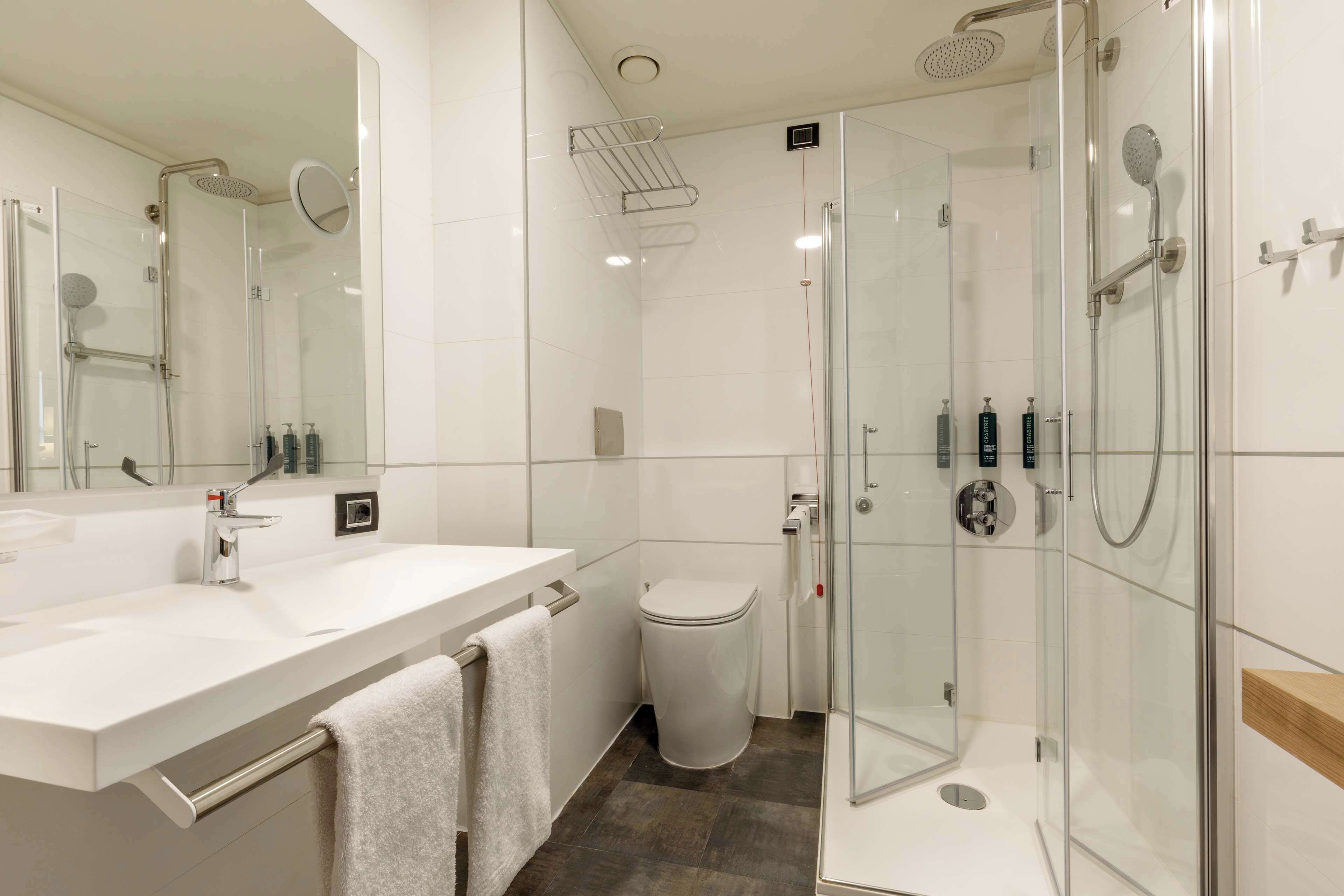 standard twin accessible room | bathroom | rainfall showerhead, designer toiletries, hair dryer, slippers