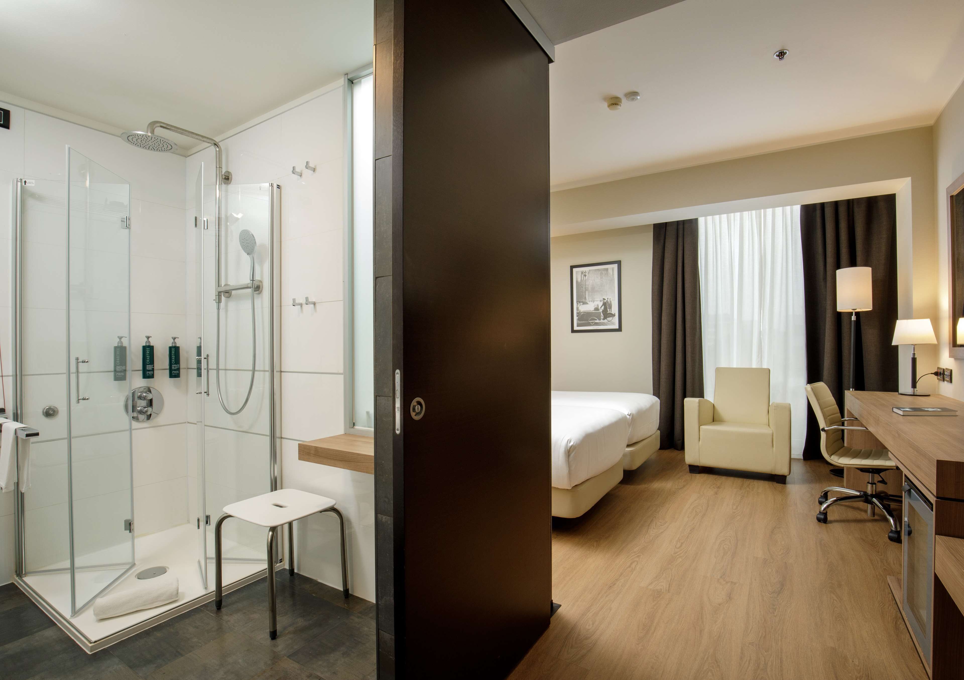 standard twin accessible room | bathroom | rainfall showerhead, designer toiletries, hair dryer, slippers