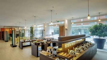 A modern breakfast bar with a variety of food items and a coffee station.