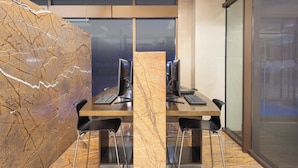 A modern office space with a marble wall, two desks with computers, and black chairs. - Holiday Inn Express Beijing Temple of Heaven by IHG (Beijing)
