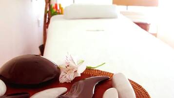 Experience ultimate relaxation on a serene massage table, surrounded by a peaceful ambiance.