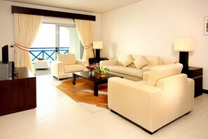 Santorini Deluxe | Living area | Flat-screen TV, DVD player - Thunderbird Resorts - Poro Point (San Fernando)