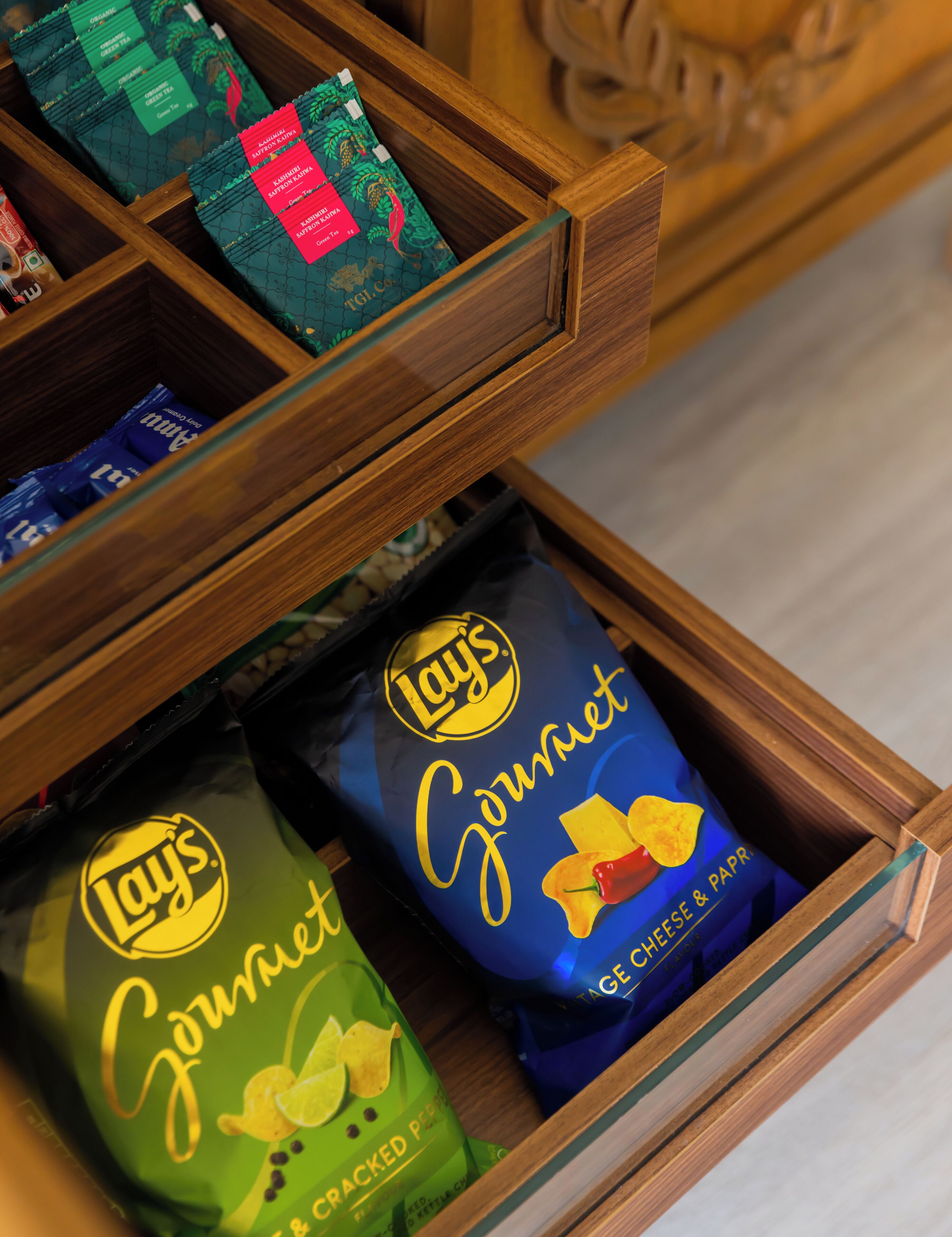 A drawer with various snack bags, including Lay's Gourmet and other brands.