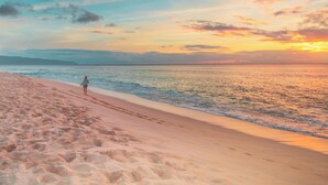 A beach with a person walking along the shore. - Heritage Village Resort & Spa Goa (Cansaulim)