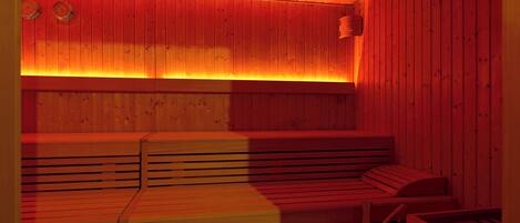 Una sauna con bancos de madera y techo inclinado.