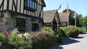 A traditional half-timbered building with a stone base and a pitched roof. - The Horseshoe Inn (Hailsham)