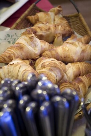 A basket of croissants on a table.
