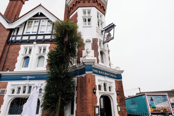 The Railway Hotel with a prominent sign, brick facade, and a large window. - The Railway Hotel Worthing (Worthing)