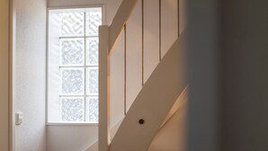 A staircase with a window in the background.
