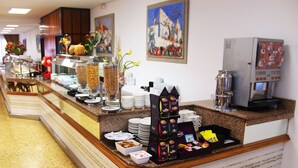 A buffet counter with various food items, condiments, and a coffee machine. - Hotel Tropical (Sant Antoni de Portmany)