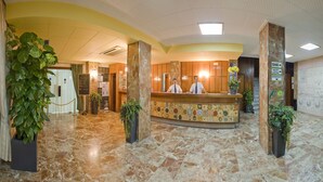 A hotel lobby with a reception desk, a staircase, and a sign indicating a public internet access area. - Hotel Tropical (Sant Antoni de Portmany)