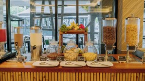 A breakfast buffet with various food options and a coffee machine. - Railay Bay Resort and Spa (Krabi)