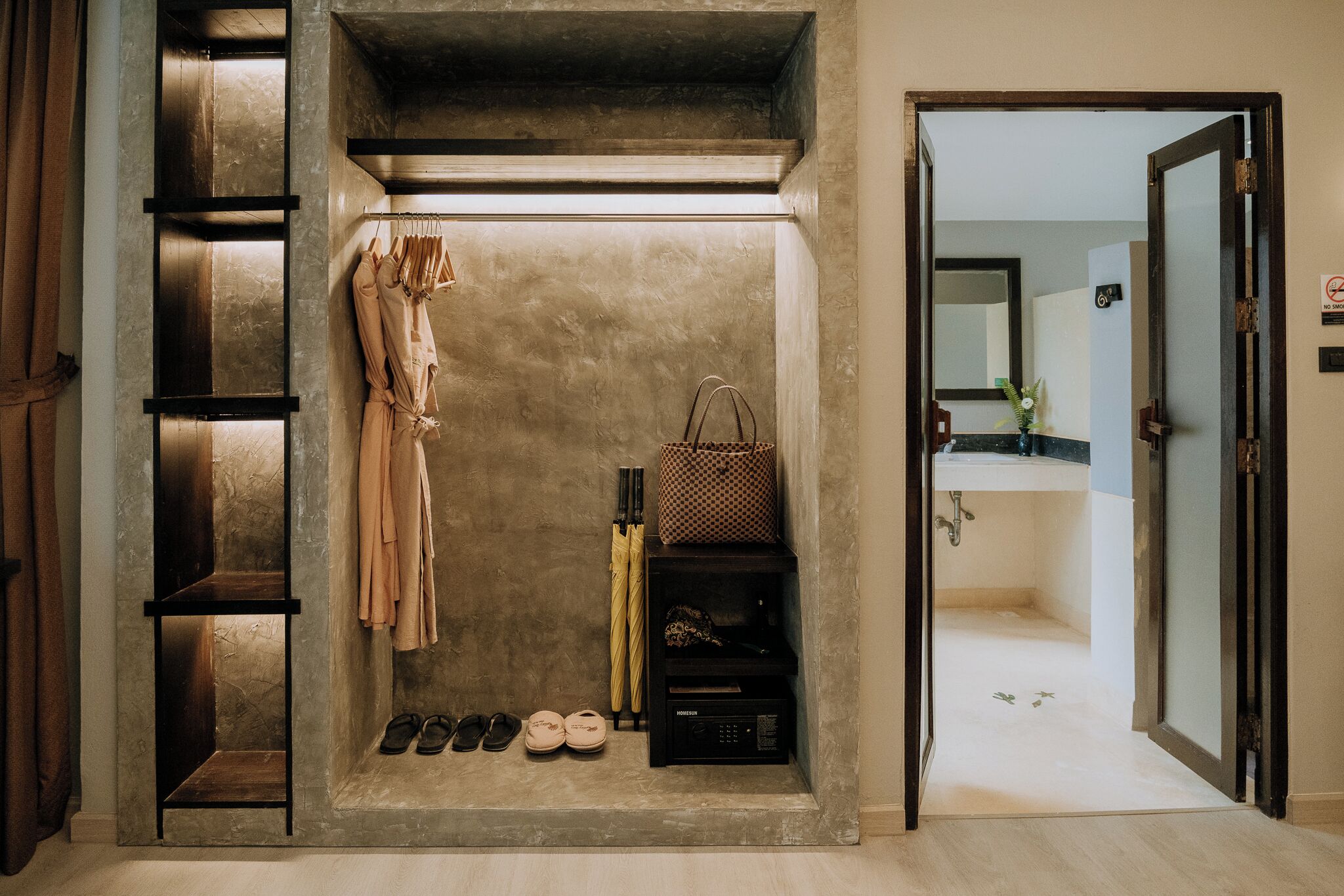 A walk-in closet with hanging clothes, a storage unit, and a shoe rack.
