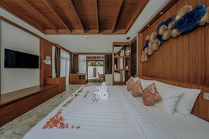 A hotel room with a bed, a TV, a wooden ceiling, and a view of the outside. - Railay Bay Resort and Spa (Krabi)