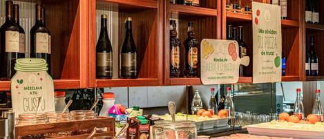 A bar area with shelves of wine bottles, a cheese and sausage board, and a sign promoting fruit.