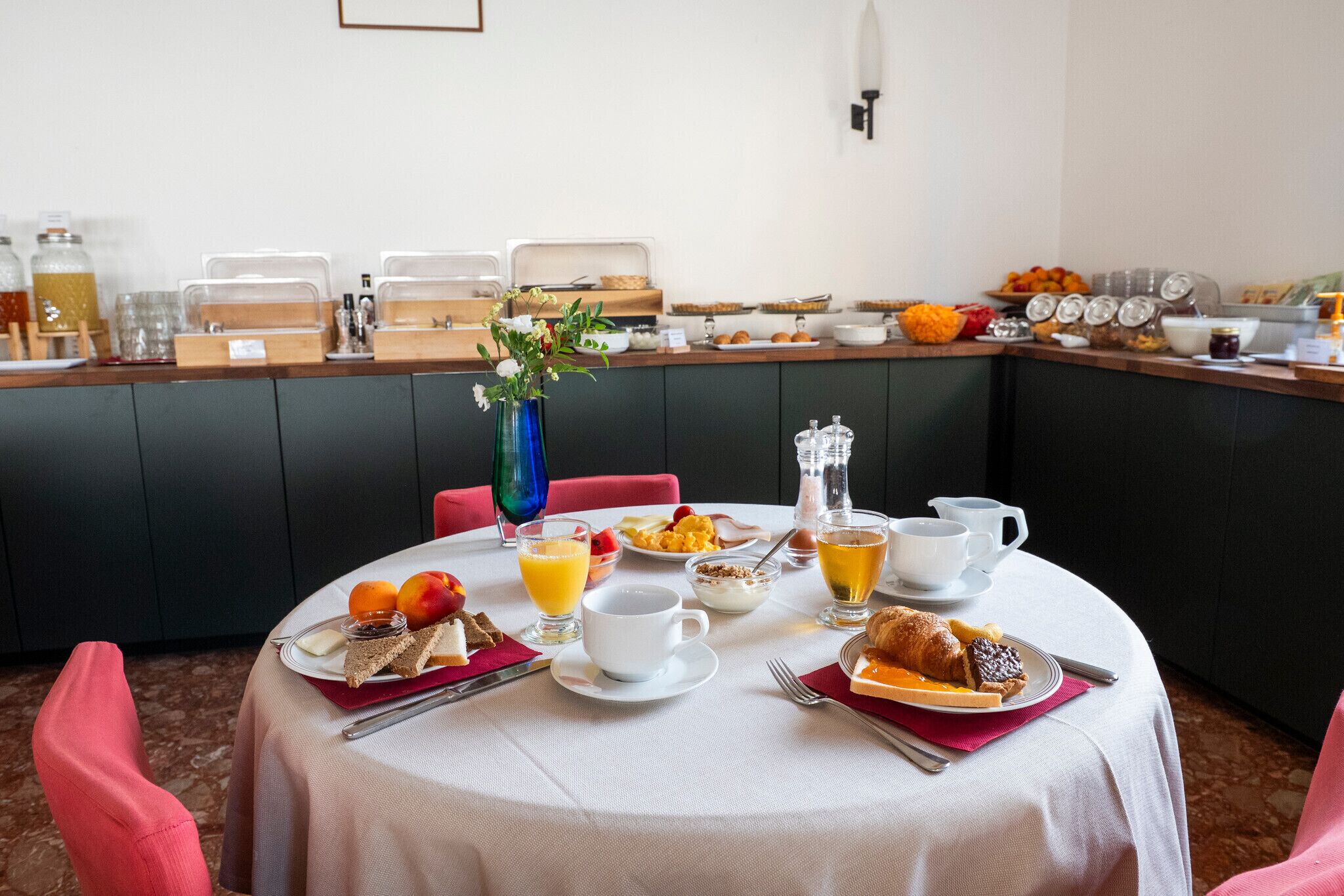 A breakfast buffet with various food items and beverages.