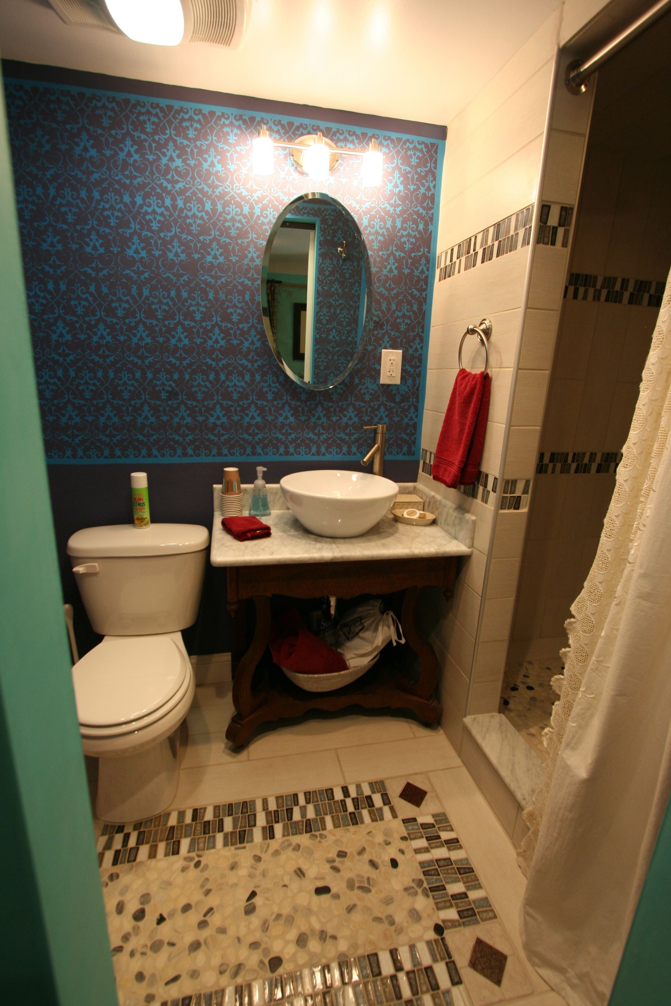 A bathroom with a toilet, sink, and shower.
