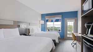 A hotel room with two beds, a desk, a chair, a television, and a window with a view. - Holiday Inn Express & Suites Lakeland North - I-4 by IHG (Lakeland)
