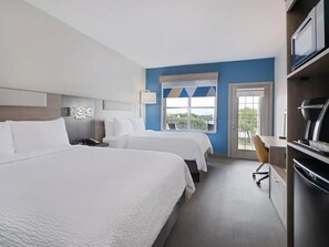 A hotel room with two beds, a desk, a chair, a television, and a window with a view. - Holiday Inn Express & Suites Lakeland North - I-4 by IHG (Lakeland)