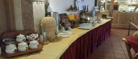 Ein reichhaltiges Buffet mit verschiedenen Speisen und Getränken, darunter eine Tablett mit Schalen und ein Korbwasserkorb.