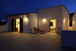 Guests can enjoy a patio with seating area and access to a welcoming interior space.